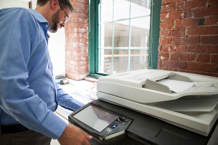 man in the office using a document scanner